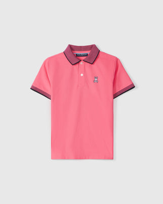 A Psycho Bunny KIDS SOUTHPORT PIQUE POLO SHIRT - B0K263B200 in pink with a purple collar and sleeve cuffs. It features a small rabbit emblem on the left chest. Crafted from Pima cotton piqué, this shirt has a three-button placket and a straight hem.