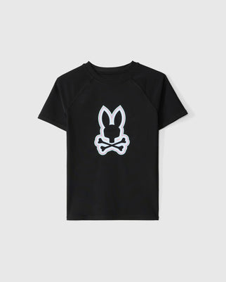 Black short-sleeved t-shirt featuring a white outline graphic of a bunny head above a pair of crossed bones on the front. The background is plain white. This KIDS SAN LEON ANTI-UV RASHGUARD - B0T645C200 by Psycho Bunny offers UPF 50+ protection, ensuring comfort and safety during outdoor adventures.