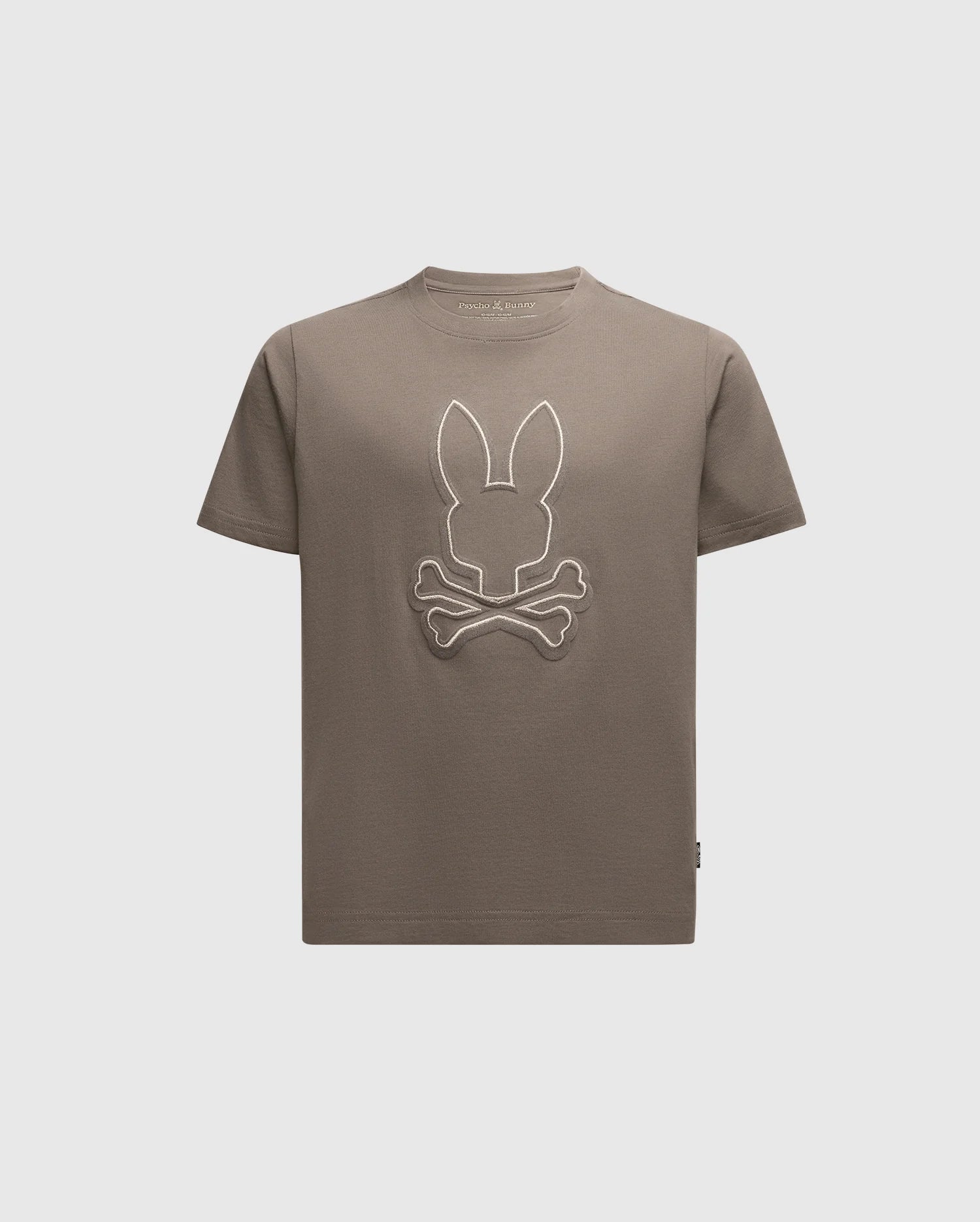 The Psycho Bunny Kids Alexander Graphic Tee (B0U163E200) is made from soft Pima cotton, featuring a khaki t-shirt with an embroidered minimalist bunny head and crossed bones design against a plain white background.