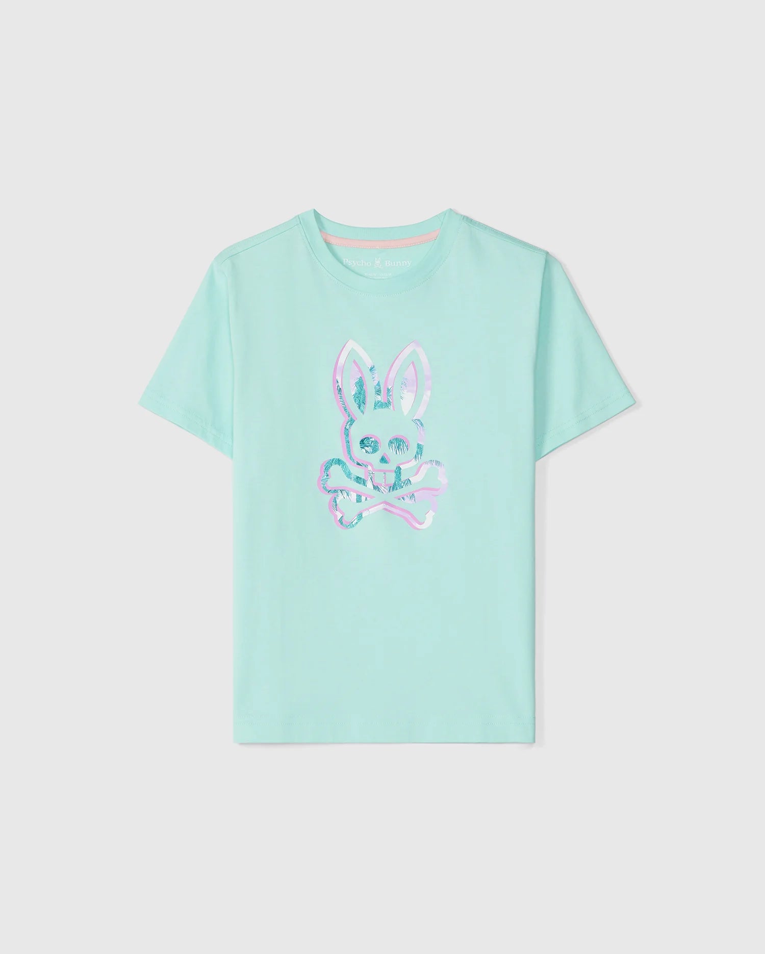 This KIDS LEONARD GRAPHIC TEE - B0U609C200 from Psycho Bunny in light blue features a bunny print with an iridescent skull and crossbones on the front. Made from luxurious Peruvian Pima cotton, it has a round neckline and short sleeves. The bunny's skull is uniquely designed with X-shaped eyes for a playful touch.