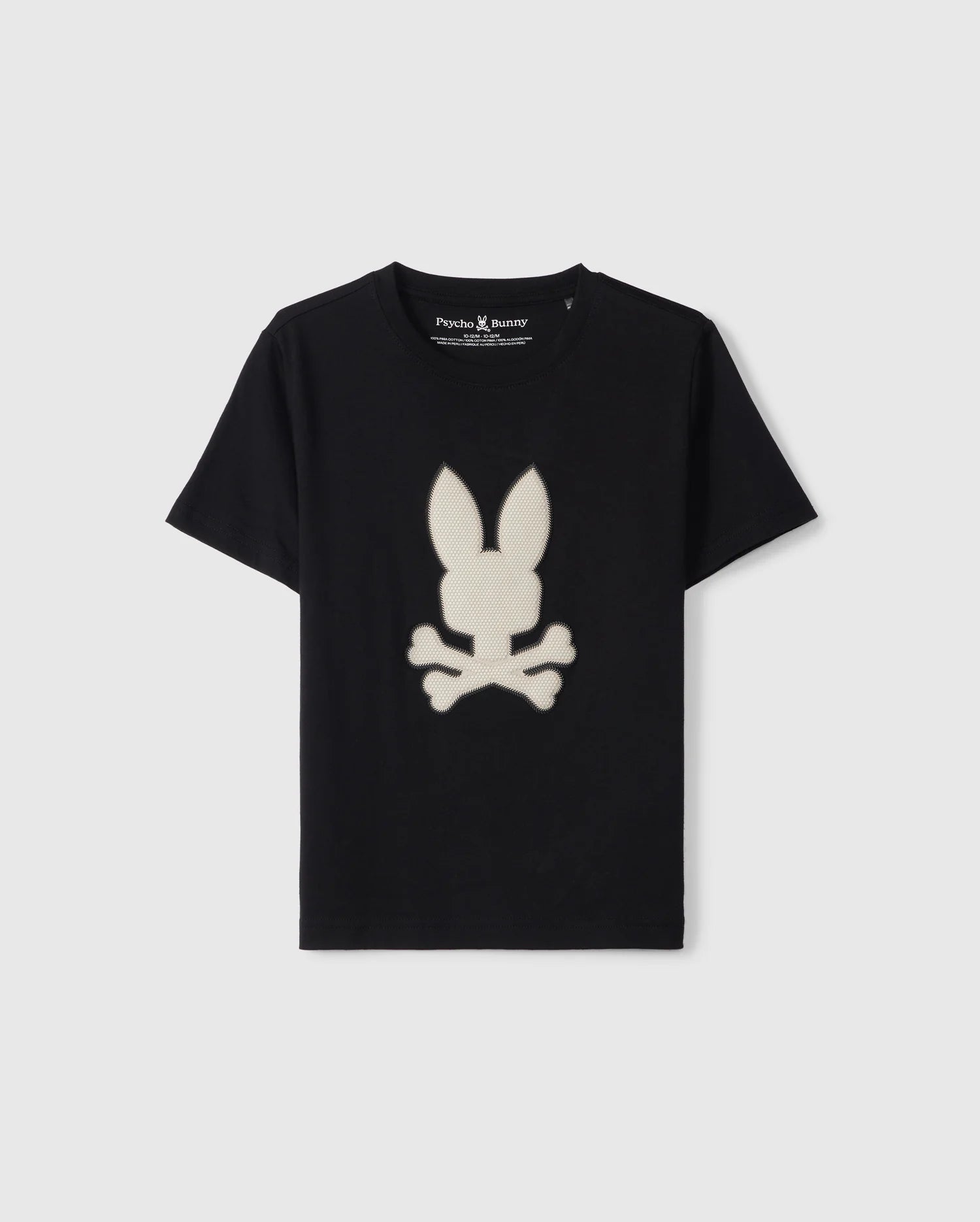 A black KIDS RIVIERA GRAPHIC TEE - B0U639C200 made from Peruvian Pima cotton, featuring a white bunny head with long ears above crossed bones in an HD-silicone design by Psycho Bunny. The shirt is displayed against a plain gray background.