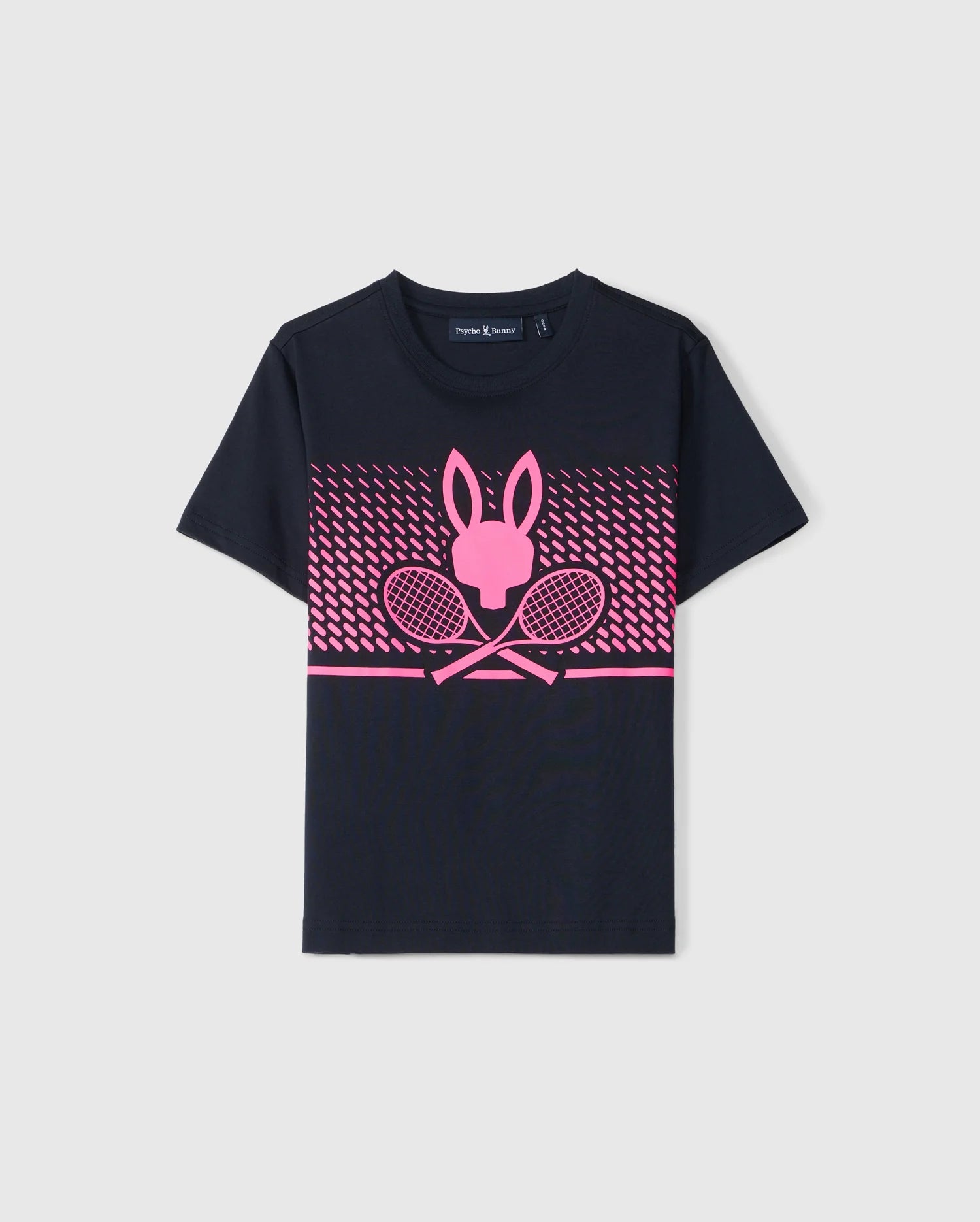 A navy blue children's t-shirt crafted from Pima cotton, featuring a pink graphic design on the chest. The graphic consists of a rabbit head silhouette above two crossed tennis rackets, with a pink gradient dot pattern in the background, celebrating the Psycho Bunny KIDS MONTREAL TOURNAMENT TEE - B0U701C200.