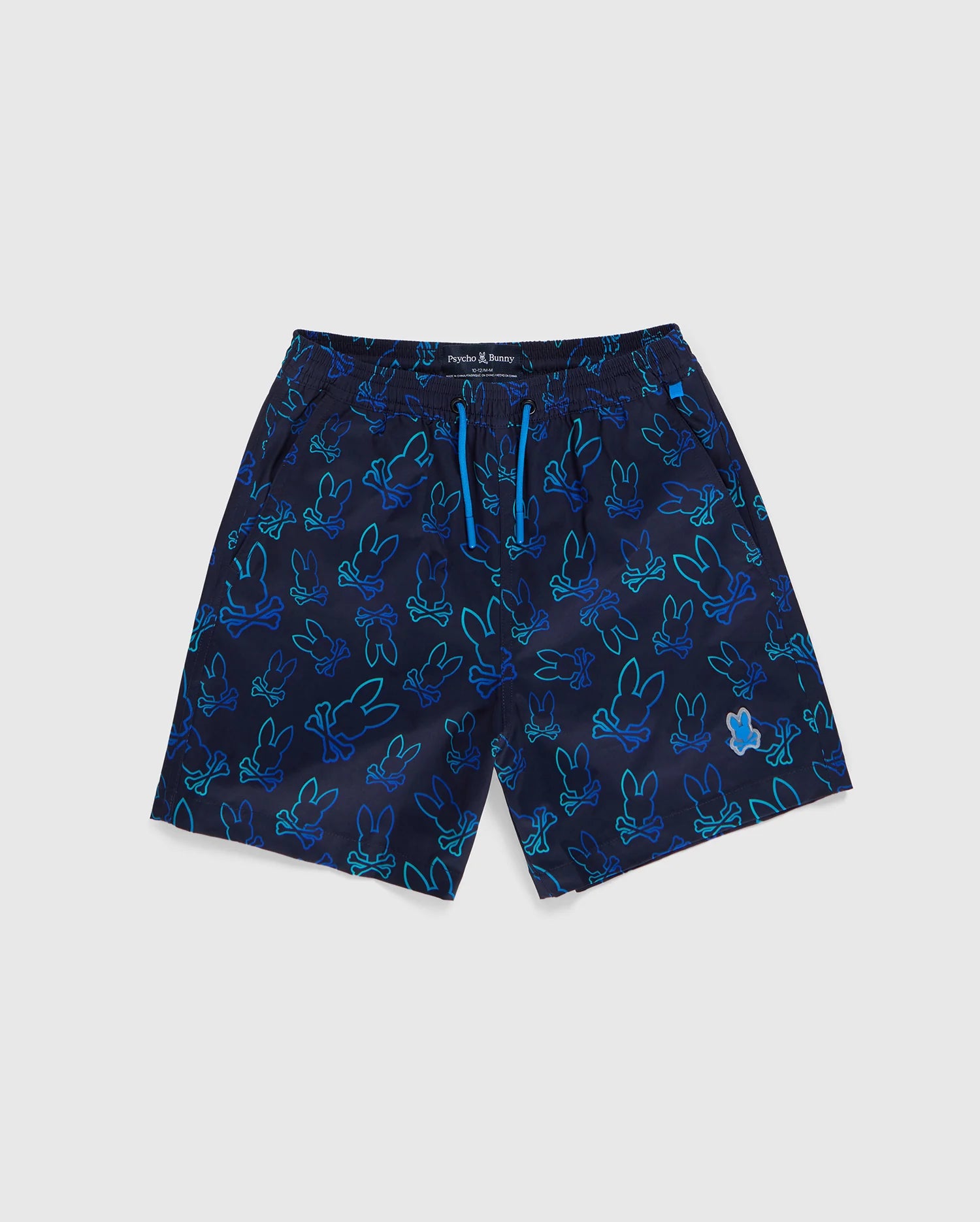 A pair of KIDS SHELDON ALL OVER PRINT SWIM TRUNK by Psycho Bunny in navy blue, adorned with a vibrant multicolored bunny pattern. These quick-dry shorts feature a blue drawstring at the waist for an adjustable fit.