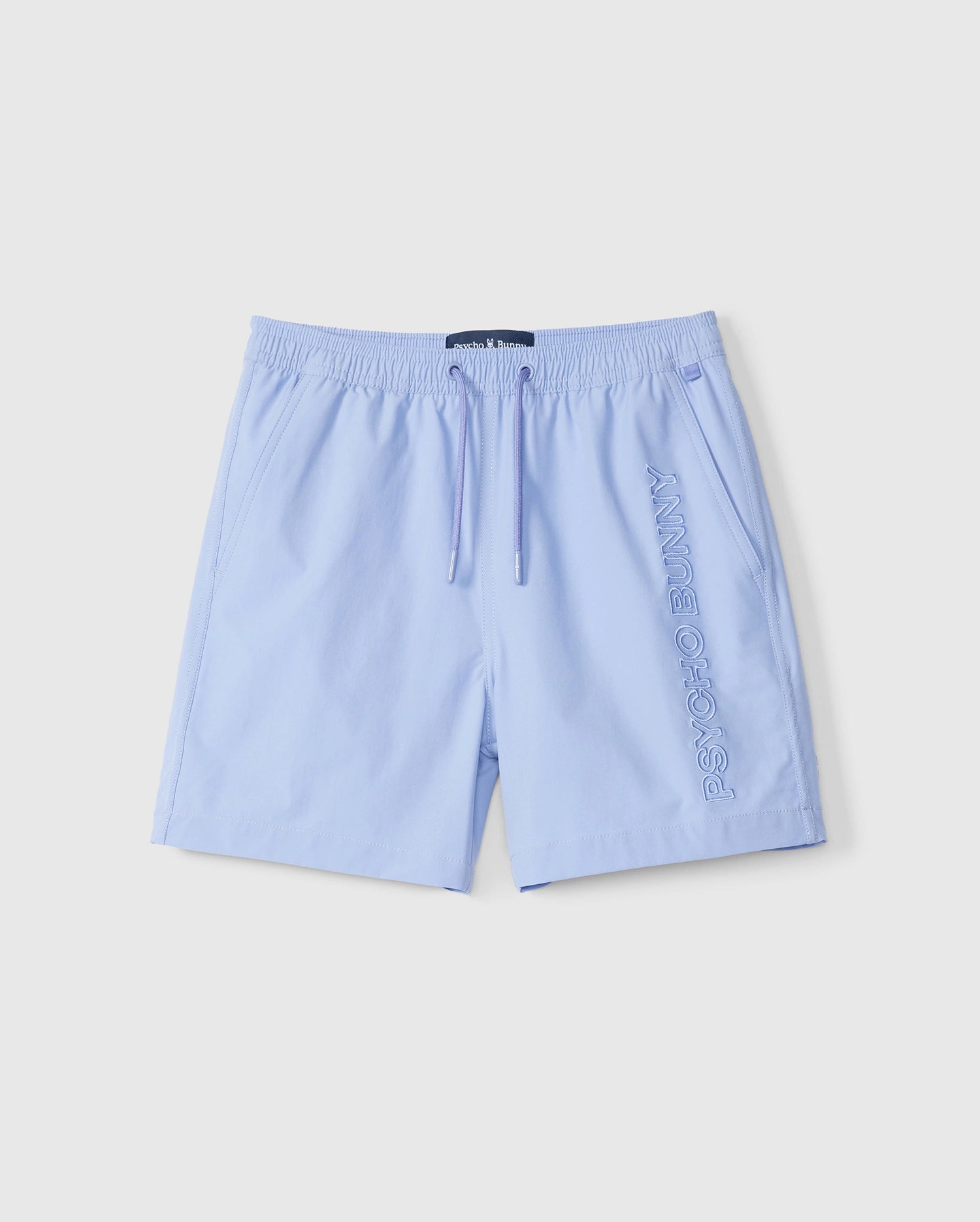 The light blue Kids Melvin Swim Trunk by Psycho Bunny (Product code: B0W665C200) features an elastic waistband and drawstring. The embroidered 