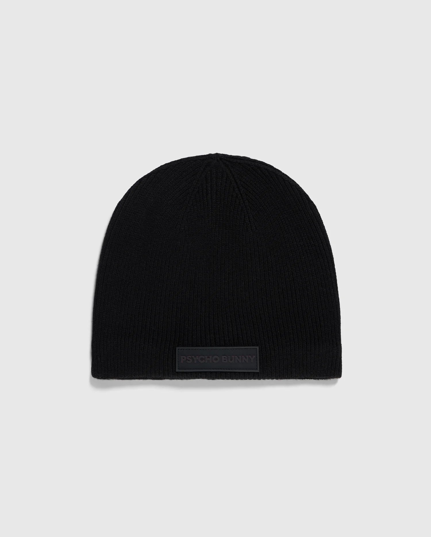 A black, stylish MENS SPORT BEANIE - B6A874D200 crafted from merino wool is displayed against a light gray background. Near the bottom edge of the beanie, there is a small rectangular patch that reads 