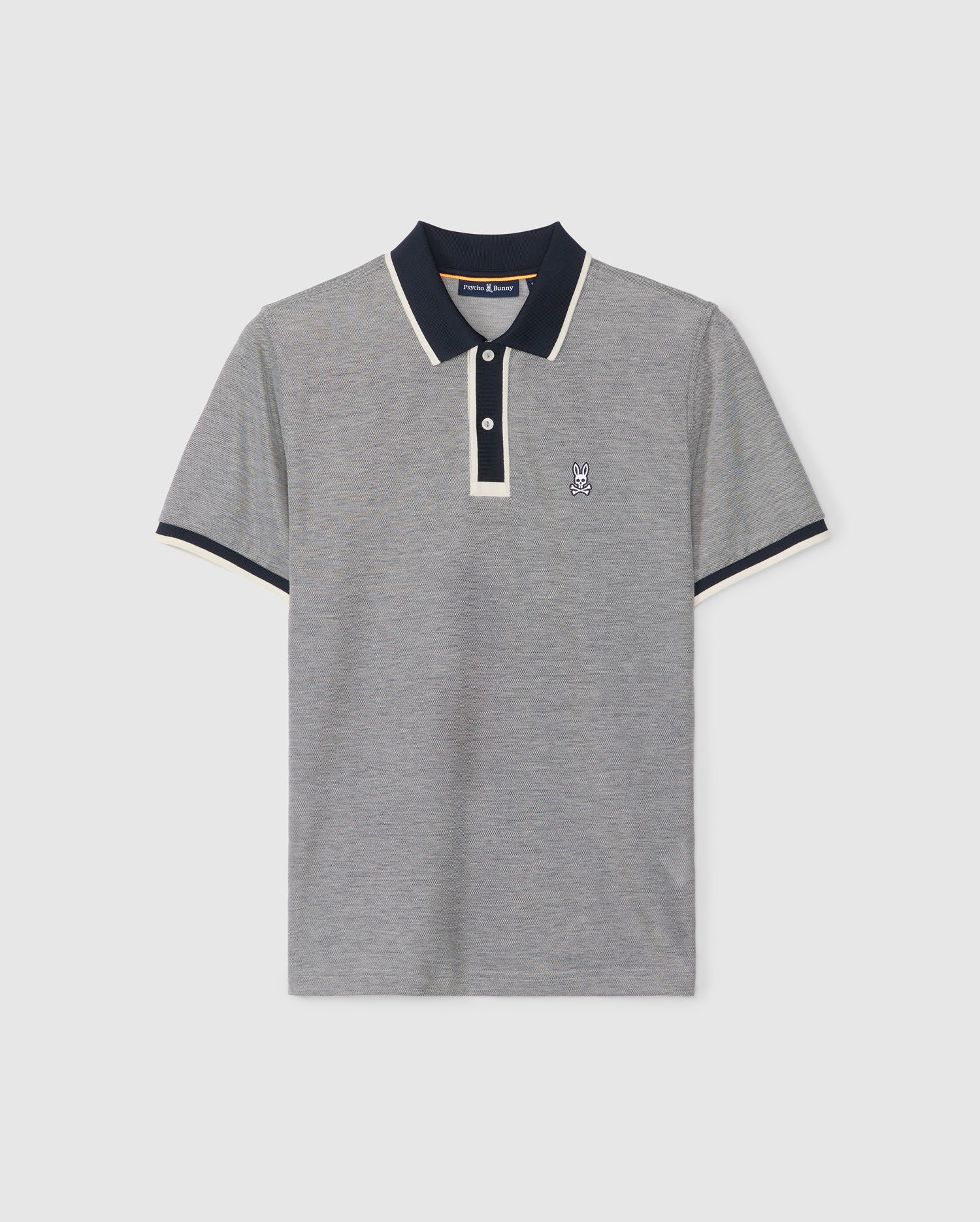 The Psycho Bunny Woodway Oxford polo shirt (product code B6K405C200) is a stylish grey top made from a Pima cotton-blend. It features a contrasting black collar and sleeve cuffs trimmed with white, along with a classic two-button placket. A small embroidered rabbit logo adorns the left chest, adding a distinctive touch.