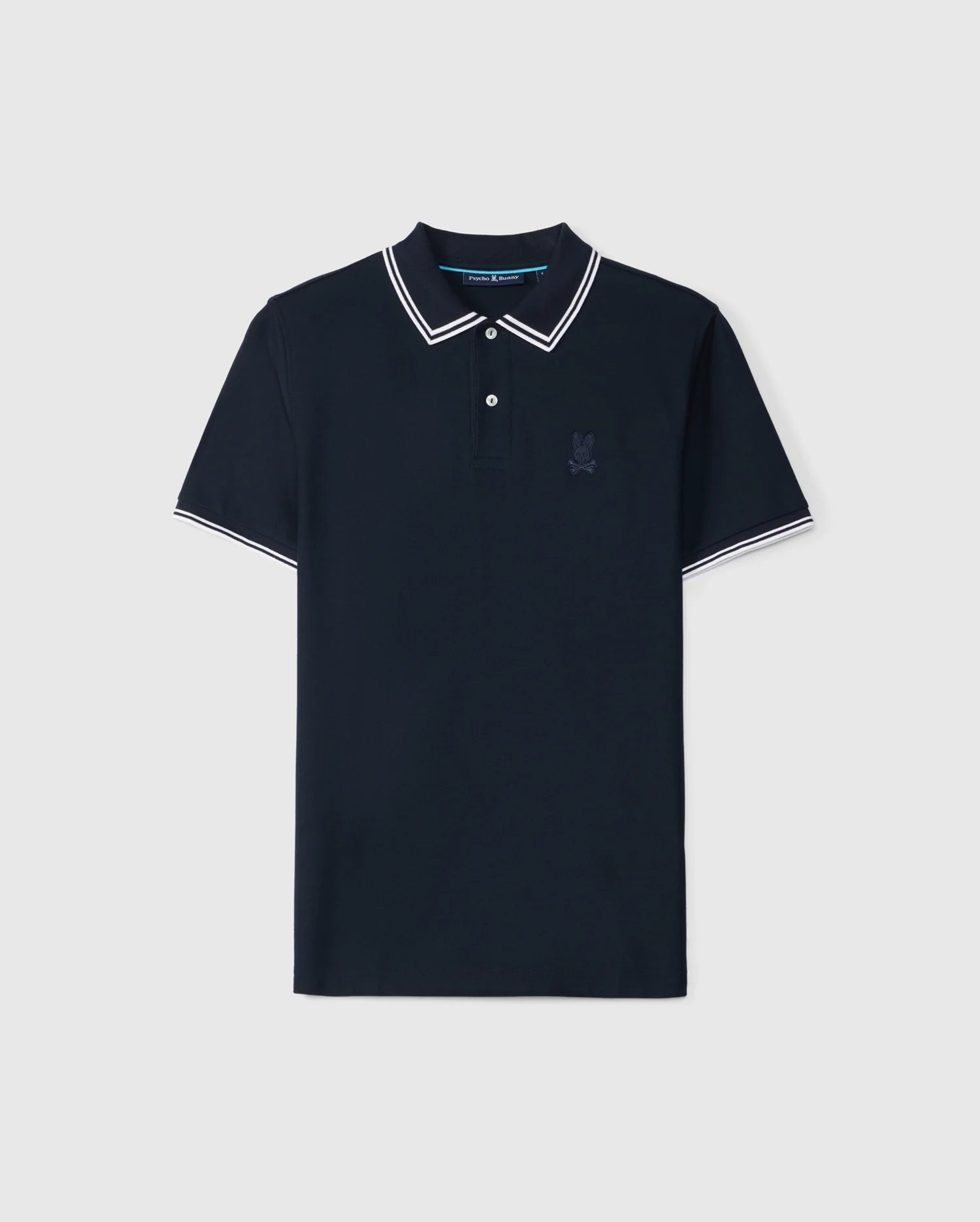 The Psycho Bunny Men's Belton Pique Polo (B6K575C200) is a short-sleeved, dark navy shirt crafted from soft Pima cotton. It features a classic collar, two-button placket, white trim on the collar and sleeve cuffs, and a small embroidered Bunny logo on the left chest.