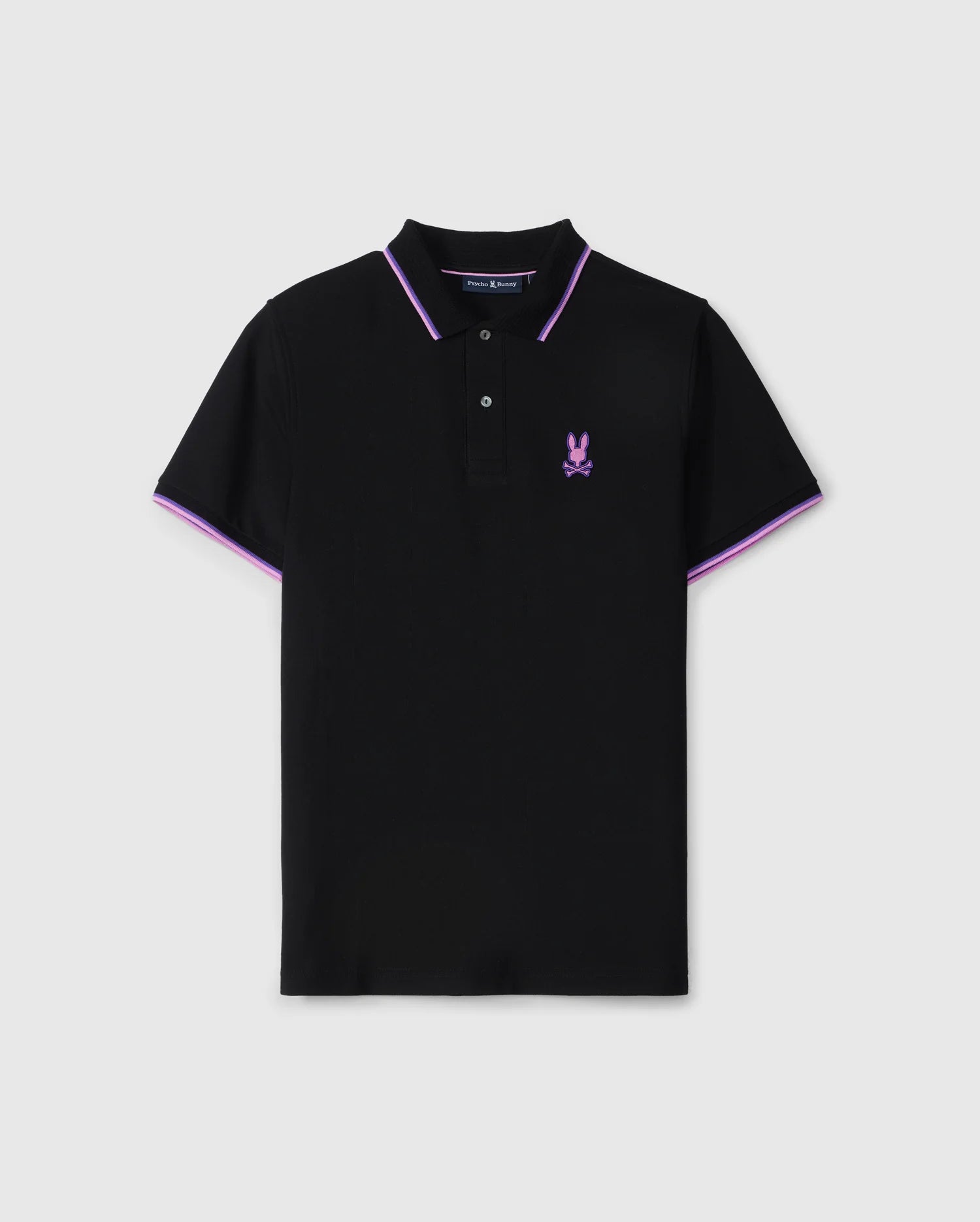 A black MENS HOUSTON PIQUE POLO SHIRT - B6K604C200 with a purple embroidered Bunny design featuring crossbones on the left chest. The shirt has a collar with purple trimming, mother-of-pearl buttons on the placket, and purple accents on the sleeves by Psycho Bunny.