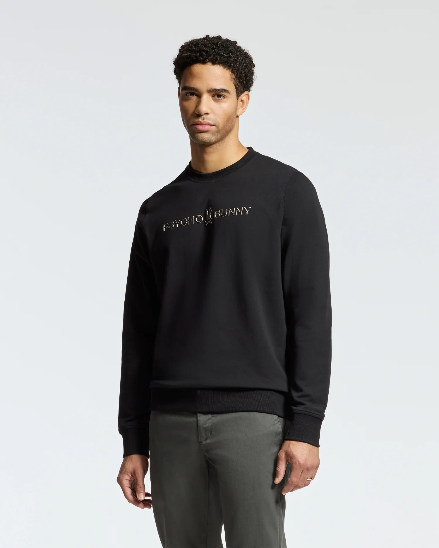 A person stands against a plain background wearing the stylish MENS LAVETA FRENCH TERRY SWEATSHIRT in black with 