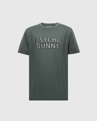 The MENS PIERCE EMBROIDERED GRAPHIC TEE by Psycho Bunny is a gray-green T-shirt featuring bold "PSYCHO BUNNY" text, crafted from premium Pima cotton. It boasts short sleeves and a classic crew neckline for ultimate comfort and style.