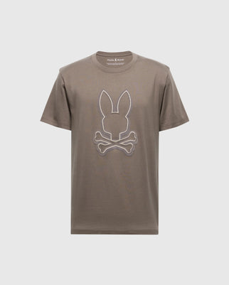 The Psycho Bunny Men's Alexander Graphic Tee (B6U163E200), in brown Pima cotton, showcases a white rabbit's head and crossbones design on the front. Featuring a crew neck and short sleeves, this shirt offers stylish comfort.