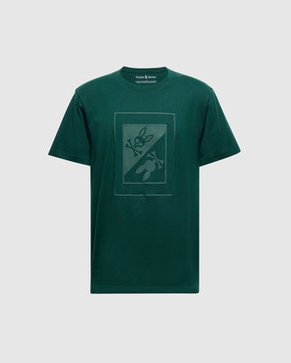 The MENS DOTSER GRAPHIC TEE by Psycho Bunny is a dark green men's T-shirt made from luxurious Peruvian Pima cotton, features a subtle puff print bunny graphic with a rocket on a plain background.