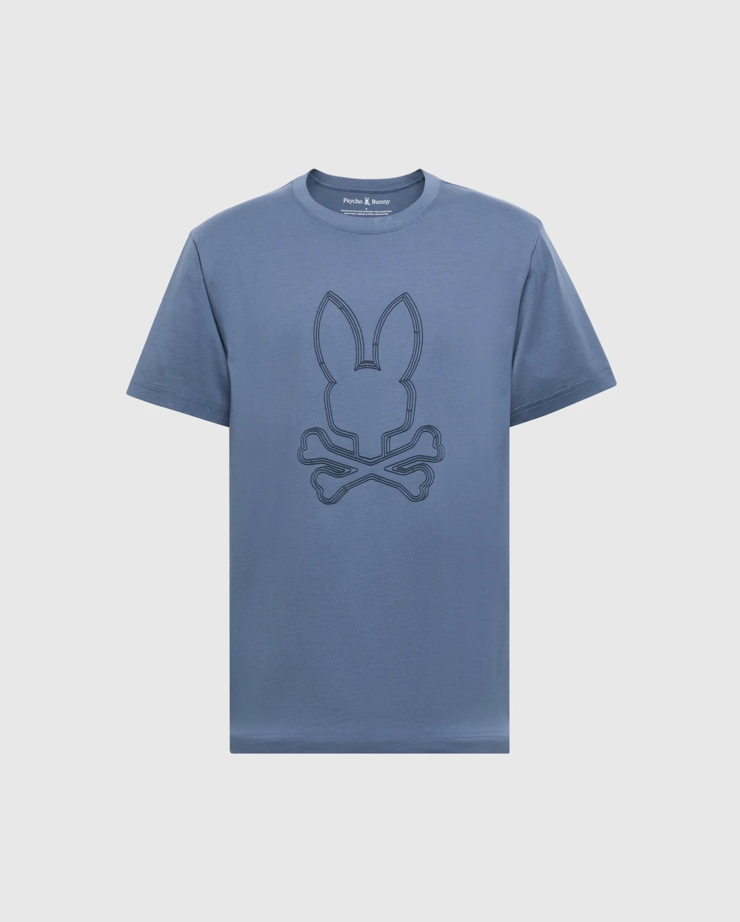 The MENS MONARC FRONT BUNNY GRAPHIC TEE by Psycho Bunny is 100% Pima cotton, featuring a stylized bunny head with crossed bones in darker blue on white, along with a round neckline and short sleeves.