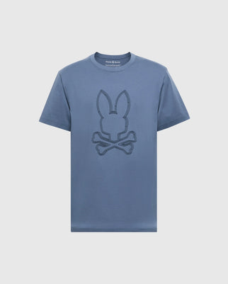 The MENS MONARC FRONT BUNNY GRAPHIC TEE by Psycho Bunny is 100% Pima cotton, featuring a stylized bunny head with crossed bones in darker blue on white, along with a round neckline and short sleeves.