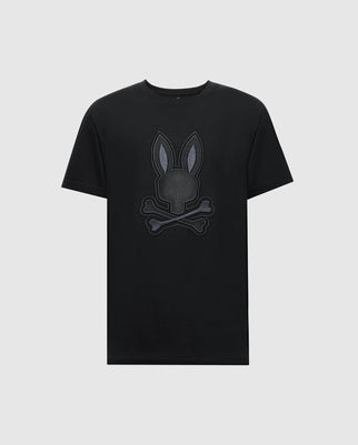 The Psycho Bunny MENS NEW CASTLE EMBROIDERED GRAPHIC TEE (B6U415F200) is a black Pima cotton tee with a central embroidered bunny emblem, featuring ears above crossed bones on a plain background.