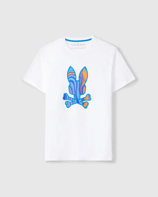 A white short-sleeve Pima cotton MENS NEVADA GRAPHIC TEE - B6U515C200 featuring a colorful abstract bunny print skull and crossbones design in blue, orange, and purple on the front. The brand name "Psycho Bunny" is visible on the inner neck label. This graphic tee is displayed against a plain grey background.