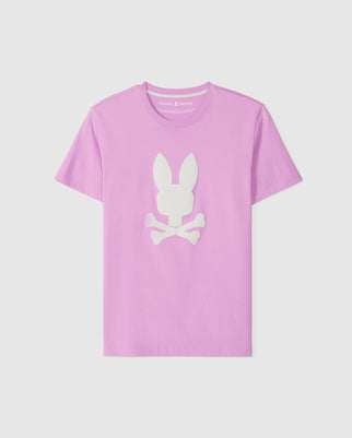 A light purple men's T-shirt made from soft Pima cotton, featuring a white graphic on the front of a rabbit's head above crossed bones, resembling a playful skull and crossbones design. The crew neckline adds to the classic appeal of this unique Psycho Bunny MENS HOUSTON GRAPHIC TEE - B6U607C200.