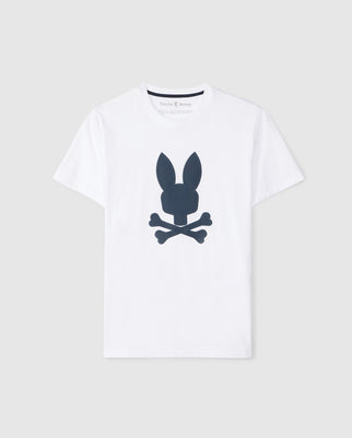 A white graphic tee featuring a black graphic design of a bunny head with crossed bones underneath, resembling a Jolly Roger symbol. Made from soft Pima cotton, the brand name "Psycho Bunny" is visible on the inner label at the neck. The MENS HOUSTON GRAPHIC TEE - B6U607C200 by Psycho Bunny is displayed against a plain gray background.