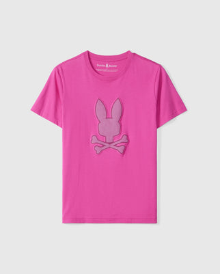 The Psycho Bunny MENS RIVIERA GRAPHIC TEE - B6U639C200 is a bright pink graphic tee featuring a shaded pink bunny head with crossbones below it in the center, giving the design a slightly raised appearance. Made from soft Peruvian Pima cotton, this tee ensures all-day comfort with its round neckline.