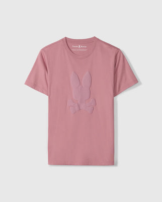 The Psycho Bunny Men's Kingston Graphic Tee (B6U743D200) is set against a light gray background and made from soft Pima cotton, featuring a subtle embossed Bunny graphic logo on the front for a stylish yet comfortable look.