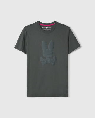 The Psycho Bunny MENS KINGSTON GRAPHIC TEE - B6U743D200 in dark gray showcases a trendy embossed bunny graphic on the front. Made from soft Pima cotton, it includes a round neck and short sleeves, set against a plain background.