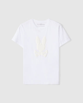 The Psycho Bunny Men's Kingston Graphic Tee - B6U743D200 is a white Pima cotton T-shirt featuring a centered embossed bunny graphic with crossed bones. It boasts short sleeves and a round neckline for optimal comfort and style.