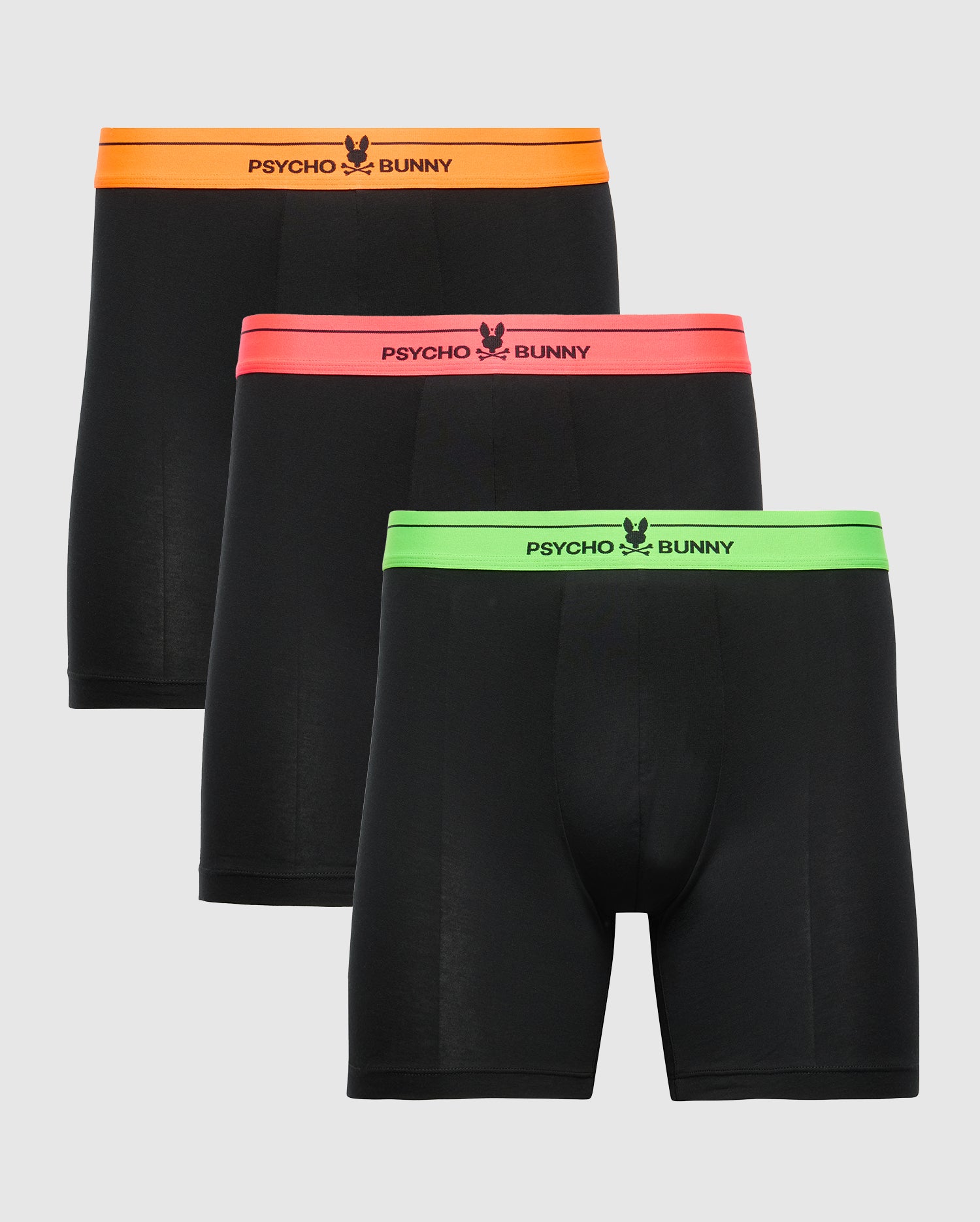 Three pairs of the MENS 3 PACK BOXER BRIEF - B6V347E200 by Psycho Bunny are showcased, crafted from soft Pima cotton. Each pair features a unique waistband color: orange for the first, pink for the second, and green for the third, with 