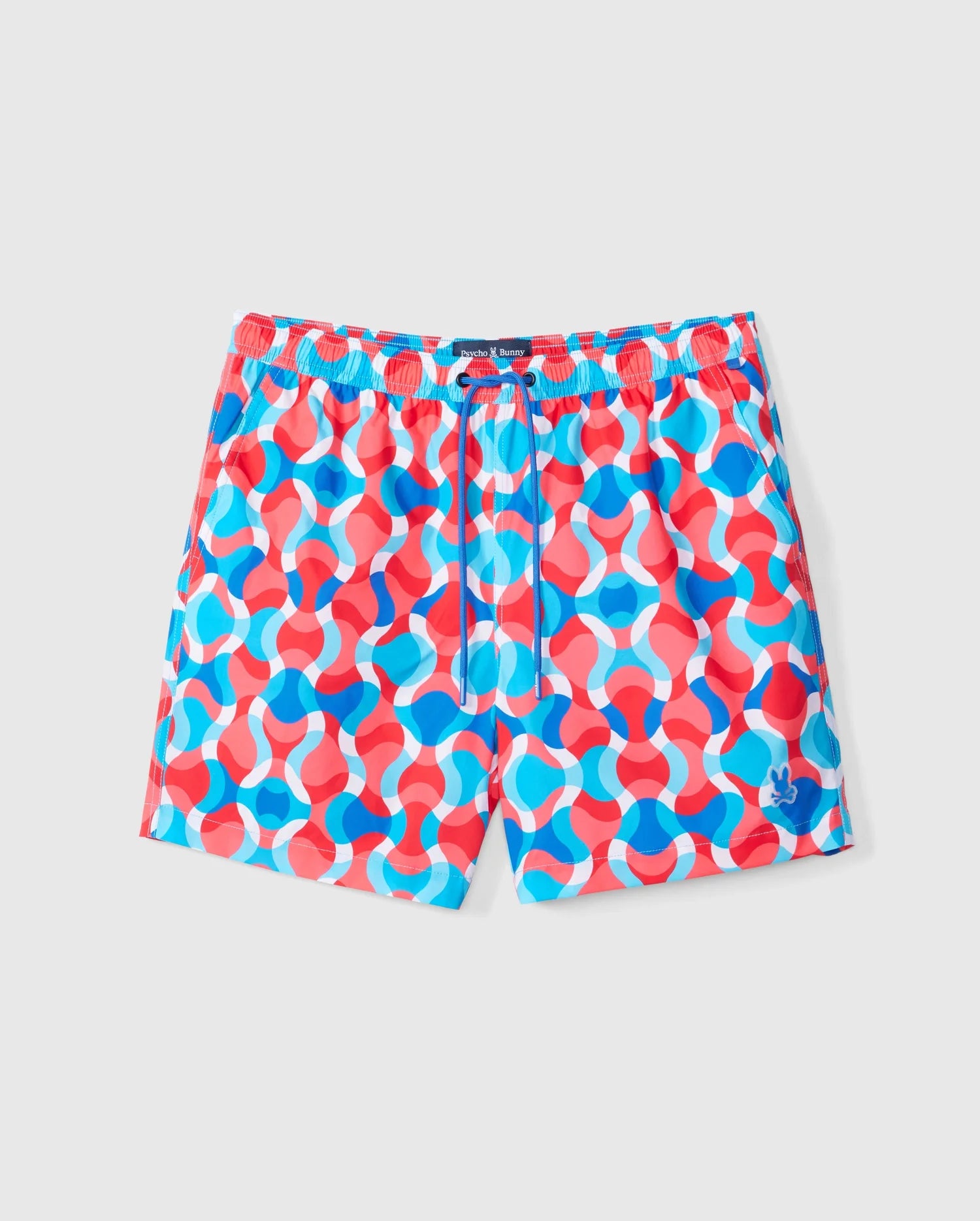 The Psycho Bunny MENS WALTER LIGHTWEIGHT PRINT SWIM TRUNK - B6W863D200 features an abstract pattern of interlocking red, blue, and white curves. These brightly-colored swim trunks are designed with a drawstring waistband and a small blue logo on the bottom right leg, making them a vibrant choice for beachgoers.